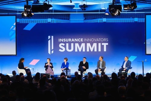 Speakers on stage at insurance event