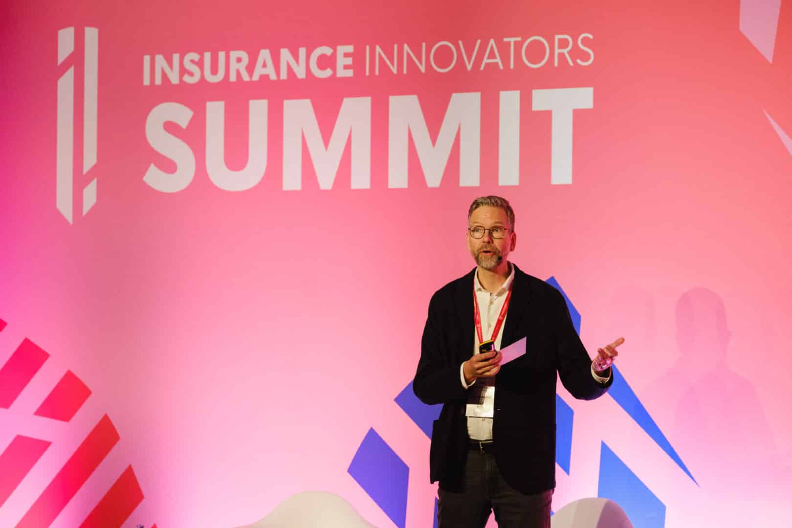 Speaker on stage at insurance event