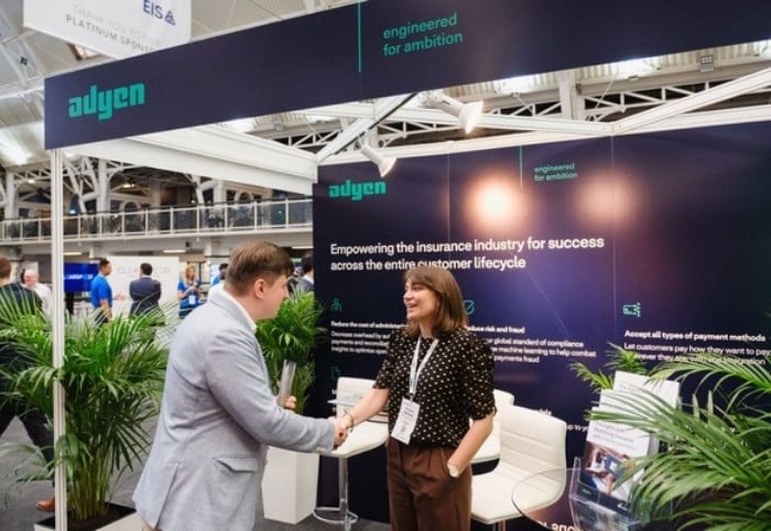 Networking at insurance conference sponsor stand