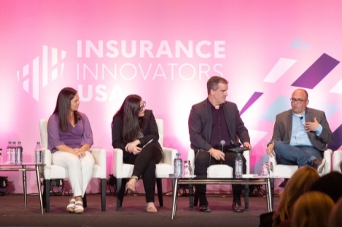 Speakers on stage at insurance event